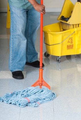 Ramalho's Cleaning Service janitor in Acton, MA mopping floor.